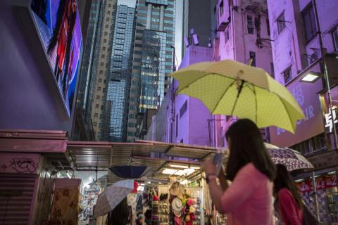 A woman with an umbrella in a city